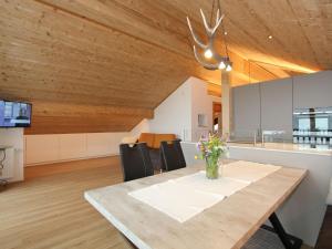 a kitchen and dining room with a wooden ceiling at Apartment with view of Schruns in Schruns-Tschagguns