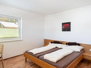 - 2 lits dans une chambre avec fenêtre dans l'établissement Elegant Apartment in Saalfelden with Balcony, à Saalfelden