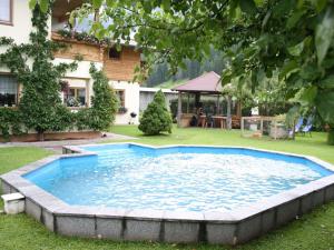 a swimming pool in the yard of a house at Apartment in Waidring near PillerseeTal Ski Area in Waidring
