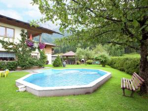 a swimming pool in the yard of a house at Charming Apartment with Shared Pool in Waidring Tyrol in Waidring