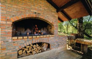 a brick oven with a pile of logs in it at Stunning Home In Ozalj With 2 Bedrooms And Wifi in Ozalj