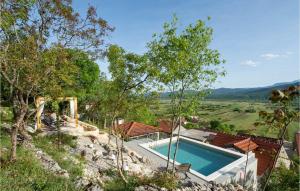 an image of a house with a swimming pool at 2 Bedroom Awesome Home In Donji Prolozac in Juričići