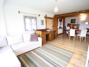 a living room with a white couch and a table at Holiday home in Liebenfels in Carinthia with sauna in Liebenfels