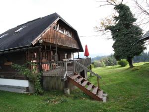 a small building with a staircase and a house at Holiday home in Liebenfels in Carinthia with sauna in Liebenfels