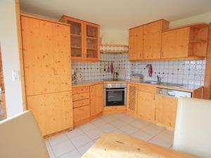 a small kitchen with wooden cabinets and a table at Holiday home in Liebenfels in Carinthia with sauna in Liebenfels