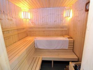 a wooden sauna with a white table in it at Holiday home in Liebenfels in Carinthia with sauna in Liebenfels