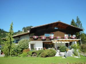 a house with flowers on the front of it at Apartment in W ngle Tyrol with Walking Trails Near in Reutte