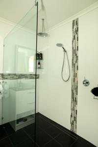 a bathroom with a shower with a glass door at Kinsellas Water Views in Albany