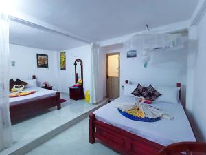Letto o letti in una camera di Sigiri Tarushan Home Stay