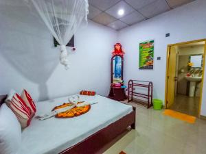 Letto o letti in una camera di Sigiri Tarushan Home Stay
