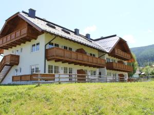a large building with wooden balconies on a hill at Apartment in St Margarethen in the ski area in Sankt Margarethen im Lungau