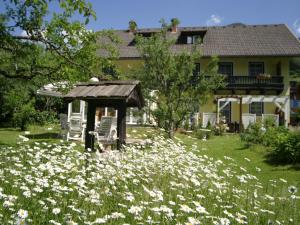 a field of flowers in front of a house at Charming Apartment in Feld am See 100 m from Lake in Feld am See