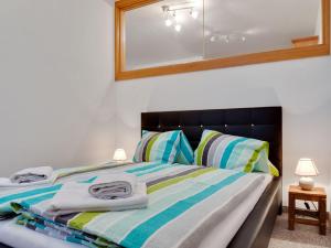 a bedroom with a bed with towels on it at Comfortable Apartment in Zell am See near Forest in Zell am See