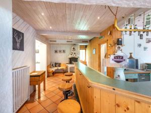 a kitchen with a counter and a living room at Holiday home near St Anton am Arlberg with sauna in Sankt Anton am Arlberg