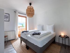 een slaapkamer met een bed met witte lakens en een raam bij Holiday home near St Anton am Arlberg with sauna in Sankt Anton am Arlberg