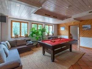 a living room with a red pool table at Holiday home near St Anton am Arlberg with sauna in Sankt Anton am Arlberg