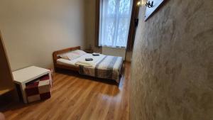 a small bedroom with a bed and a window at Dream Hostel & Apartments in Krakow