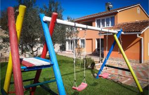 a group of colorful playground equipment in a yard at Gorgeous Home In Valbandon With Wifi in Štinjan