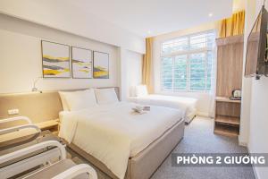 Postel nebo postele na pokoji v ubytování Keypad Hotel - 28 Dịch Vọng Hậu