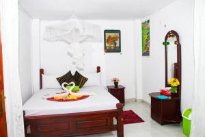 Letto o letti in una camera di Sigiri Tarushan Home Stay