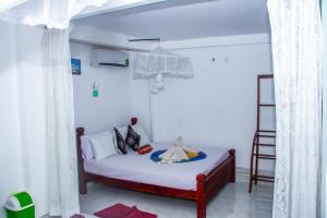 Letto o letti in una camera di Sigiri Tarushan Home Stay
