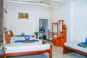 Letto o letti in una camera di Sigiri Tarushan Home Stay