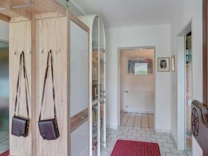 a hallway with a wooden cabinet and a red rug at Cosy Apartment in Oed hling with Garden in Mauer bei Amstetten