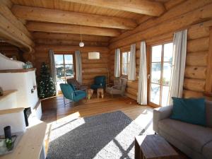 a living room in a log cabin with a christmas tree at Detached holiday home in Mauterndorf Salzburgerland near the ski area in Mauterndorf