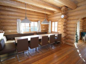 a dining room with a table and chairs in a log cabin at Detached holiday home in Mauterndorf Salzburgerland near the ski area in Mauterndorf
