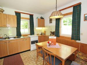 a kitchen with a wooden table and a dining room at Holiday home Reiter I in Gmünd in Kärnten