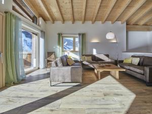 a living room with a couch and a coffee table at Modern chalet in Saalbach Hinterglemm with sauna in Saalbach-Hinterglemm