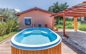 a pool in a backyard with a house at 3 Bedroom Beautiful Home In Vodnjan in Vodnjan