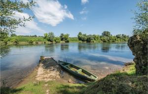 un bateau assis sur la rive d'une rivière dans l'établissement Two-Bedroom Holiday Home In Pokupska Slatina, à Pokupsko