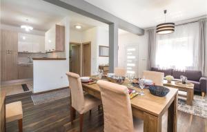 une cuisine et une salle à manger avec une table et des chaises en bois dans l'établissement Two-Bedroom Holiday Home In Pokupska Slatina, à Pokupsko