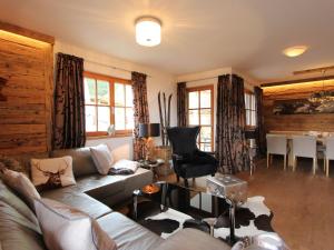 a living room with a couch and a table at Dream Panorama Chalet TOP10 right in the ski in Mittersill