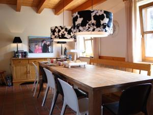 a kitchen with a large wooden table and chairs at Spacious Villa near Lake in Goldegg in Goldegg