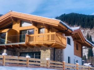 a log home with a deck on the side of it at Premium Chalet in Krimml with sauna in Krimml