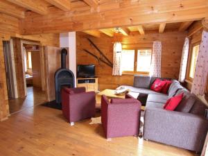 a living room with a couch and a stove at Comfortable Chalet with Whirlpool and Sauna in Krimml in Krimml