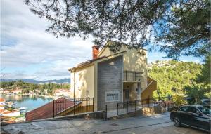 a house with a statue on top of it at One-Bedroom Apartment In Ploce in Blace