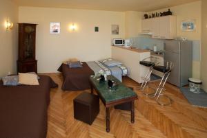 a living room with a couch and a table at Apartments Beautiful Sandy Beach in Split