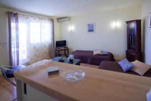 a living room with a couch and a table at Apartments Beautiful Sandy Beach in Split