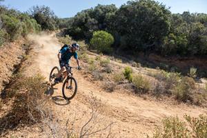 a man riding a bike on a dirt road at Pigna Felice Punta Ala in Punta Ala