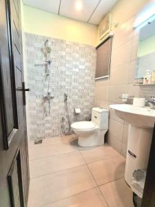 a bathroom with a toilet and a sink at Tranquil & Delightful 1 Bed Apt In Bahria Town in Rawalpindi