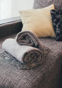 a towel sitting on top of a couch at Ring Stop Holiday Apartment in Sigulda