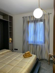 a bedroom with a bed with two towels on it at Il Vecchio Ulivo Sa Tanca in Ussàssai