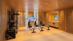 a gym with treadmills and cardio equipment in a room at The Shàng by Artyzen Qiantan Shanghai in Shanghai