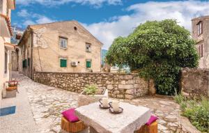 a stone alley with a table and a building at Amazing Apartment In Bakar With Kitchen in Bakar