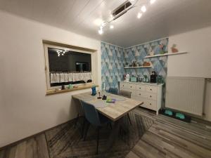 a room with a table and a dresser and a window at Ferienwohnung Hundenest im Altmühltal in Kinding +10 photos