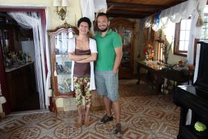 a man and a woman standing in a room at Voreades in Tinos