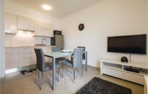 a kitchen and dining room with a table and chairs at Gorgeous Apartment In Novigrad With Kitchen in Novigrad Istria